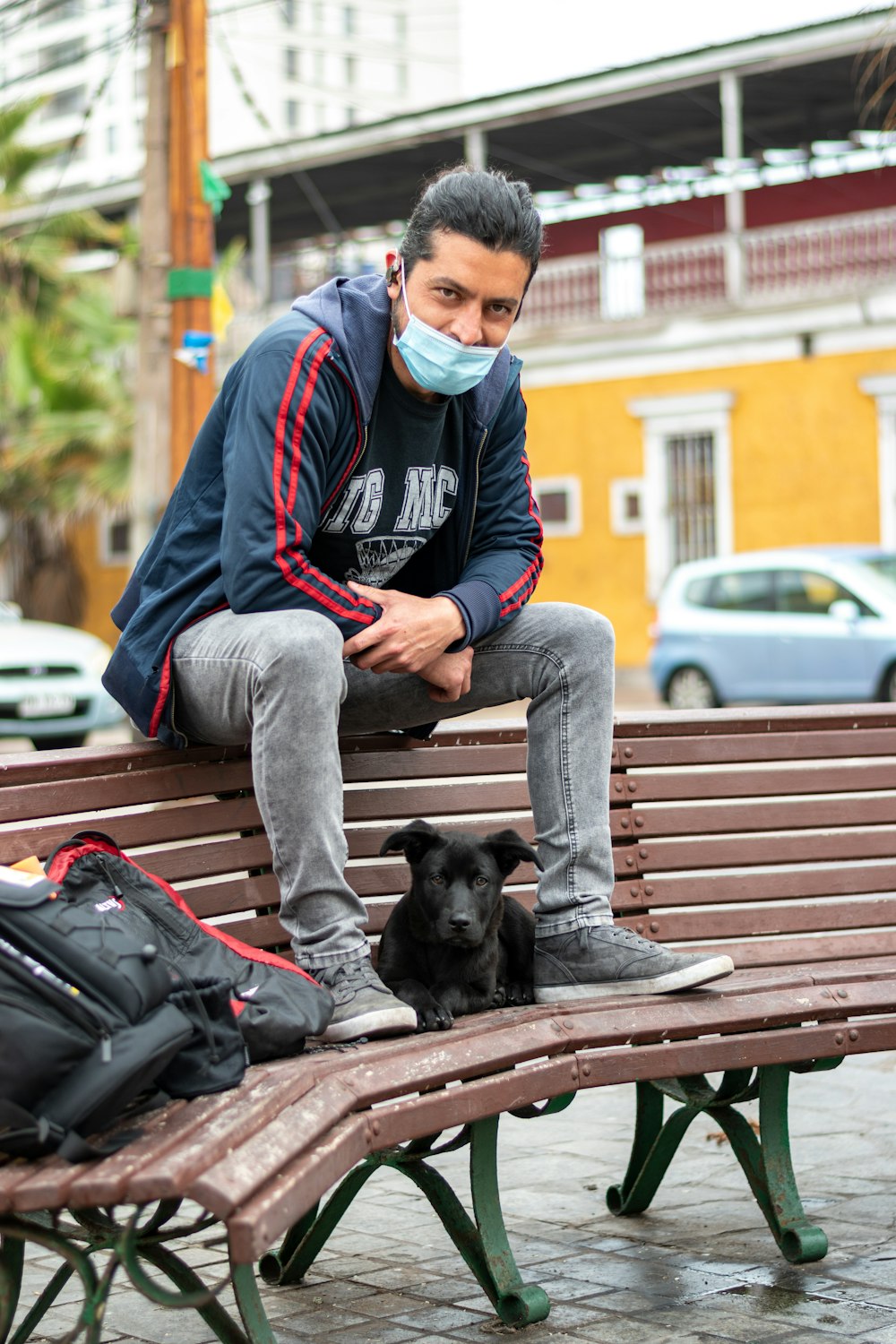 man in gray and black adidas hoodie sitting on brown wooden bench