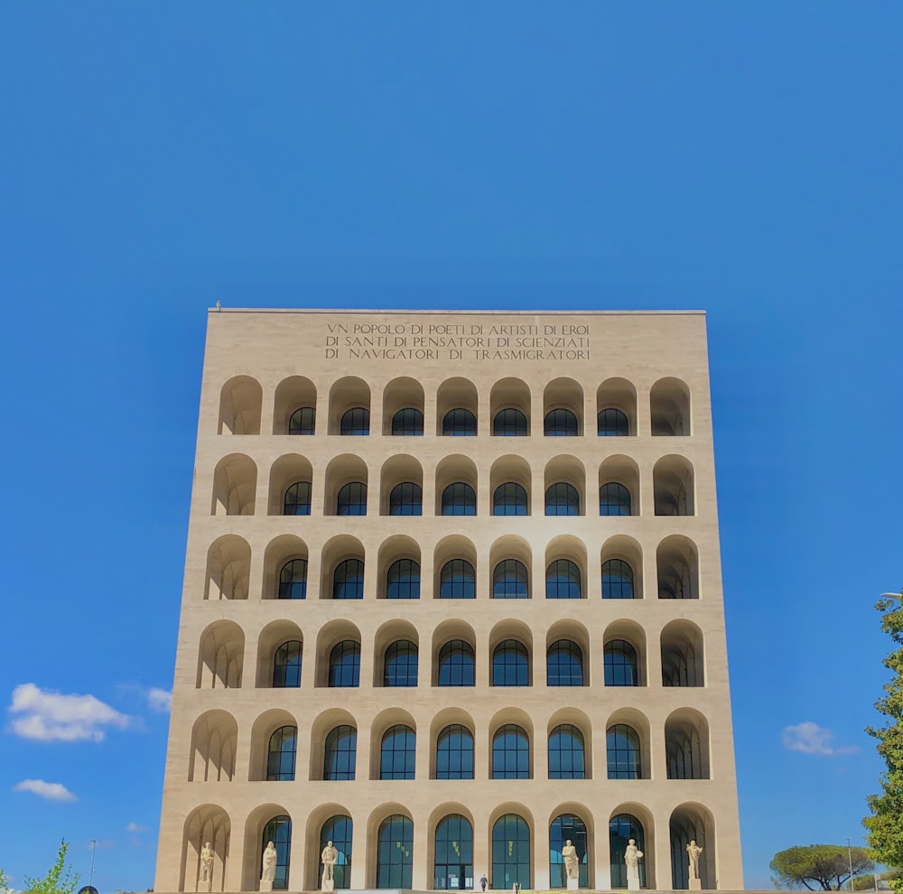 edificio in cemento bianco sotto il cielo blu durante il giorno