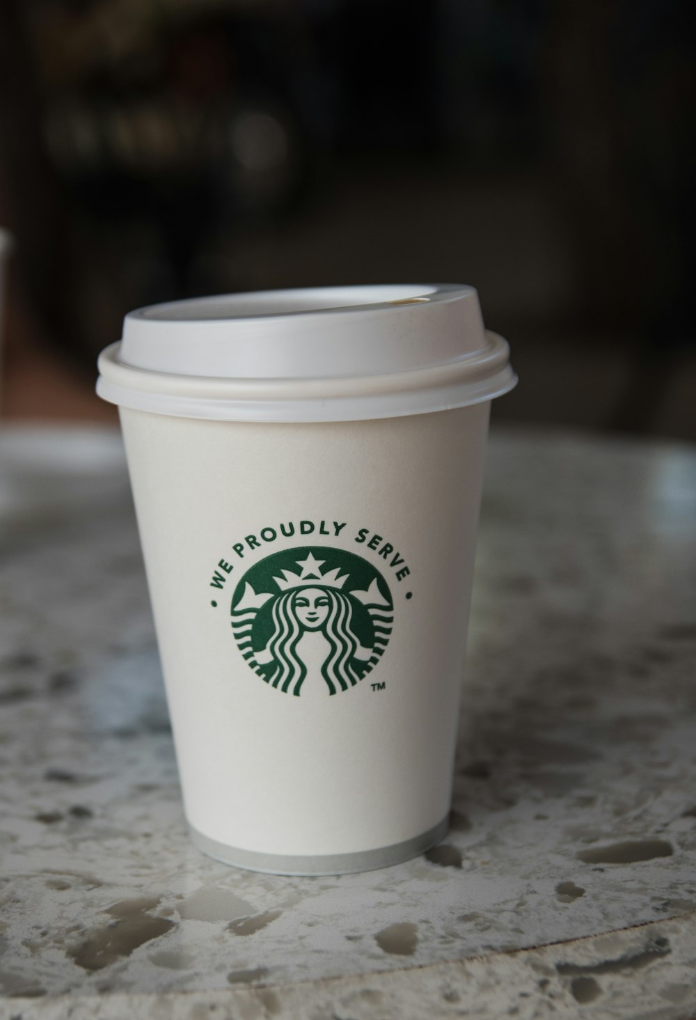 white starbucks disposable cup on gray marble table
