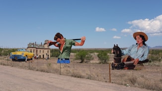 man in green t-shirt and blue denim jeans riding black horse during daytime