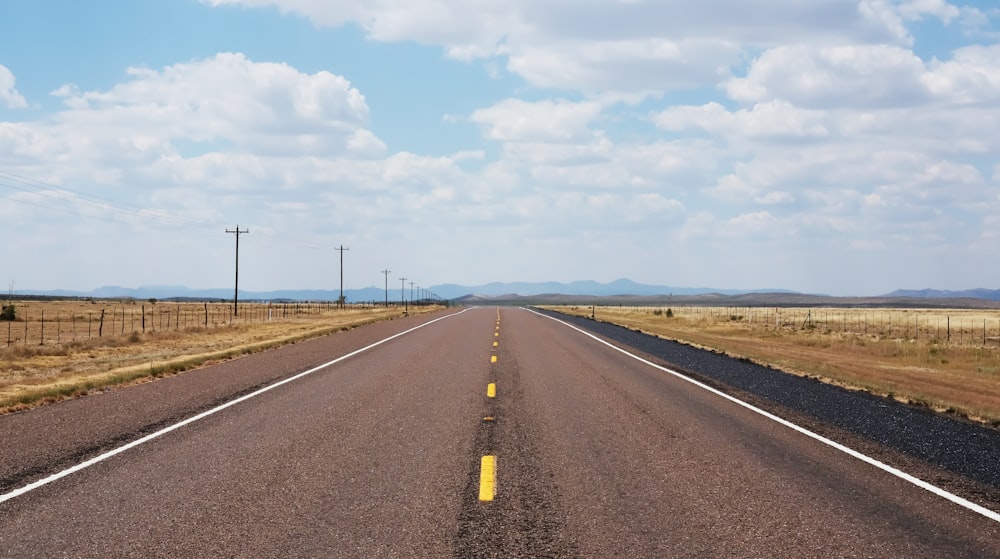 gray concrete road under blue sky during daytime