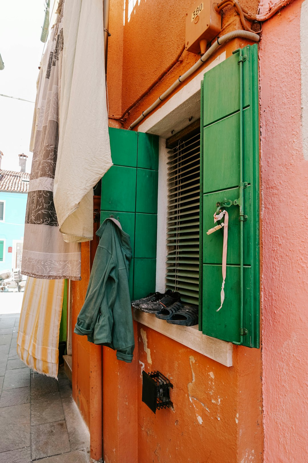 white towel hanged on green wooden door