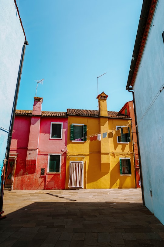 red and beige concrete building in Burano Italy