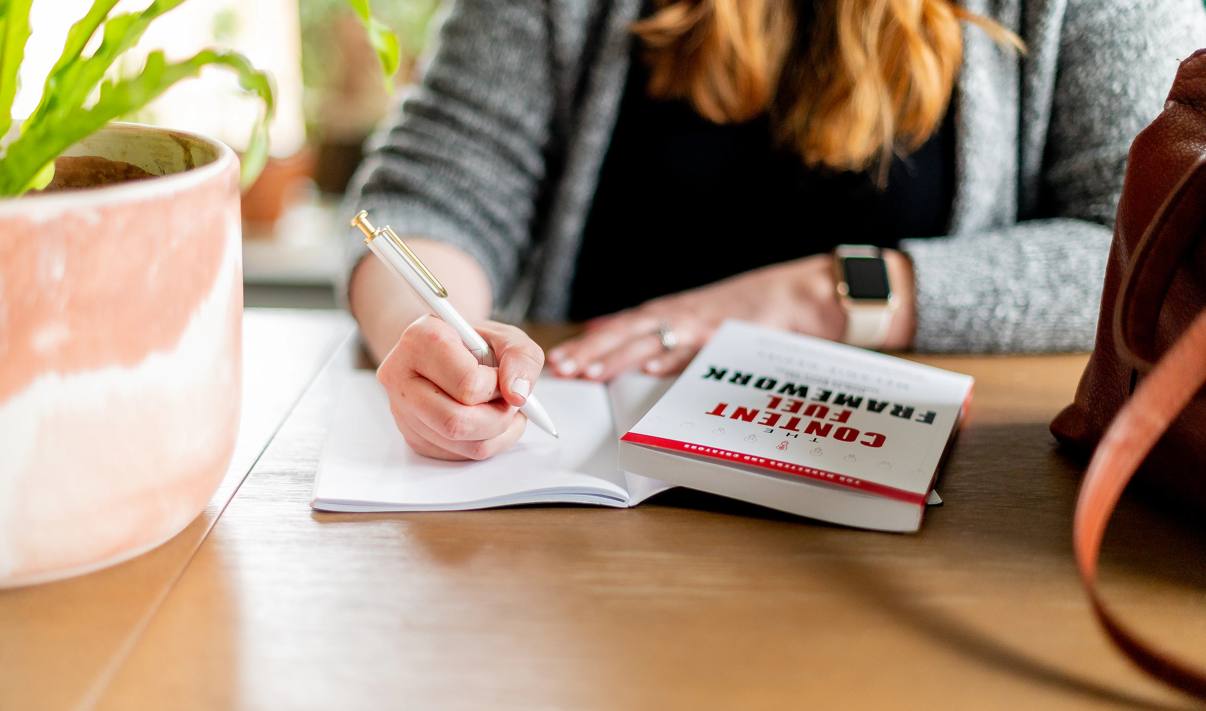 A woman writing notes on paper