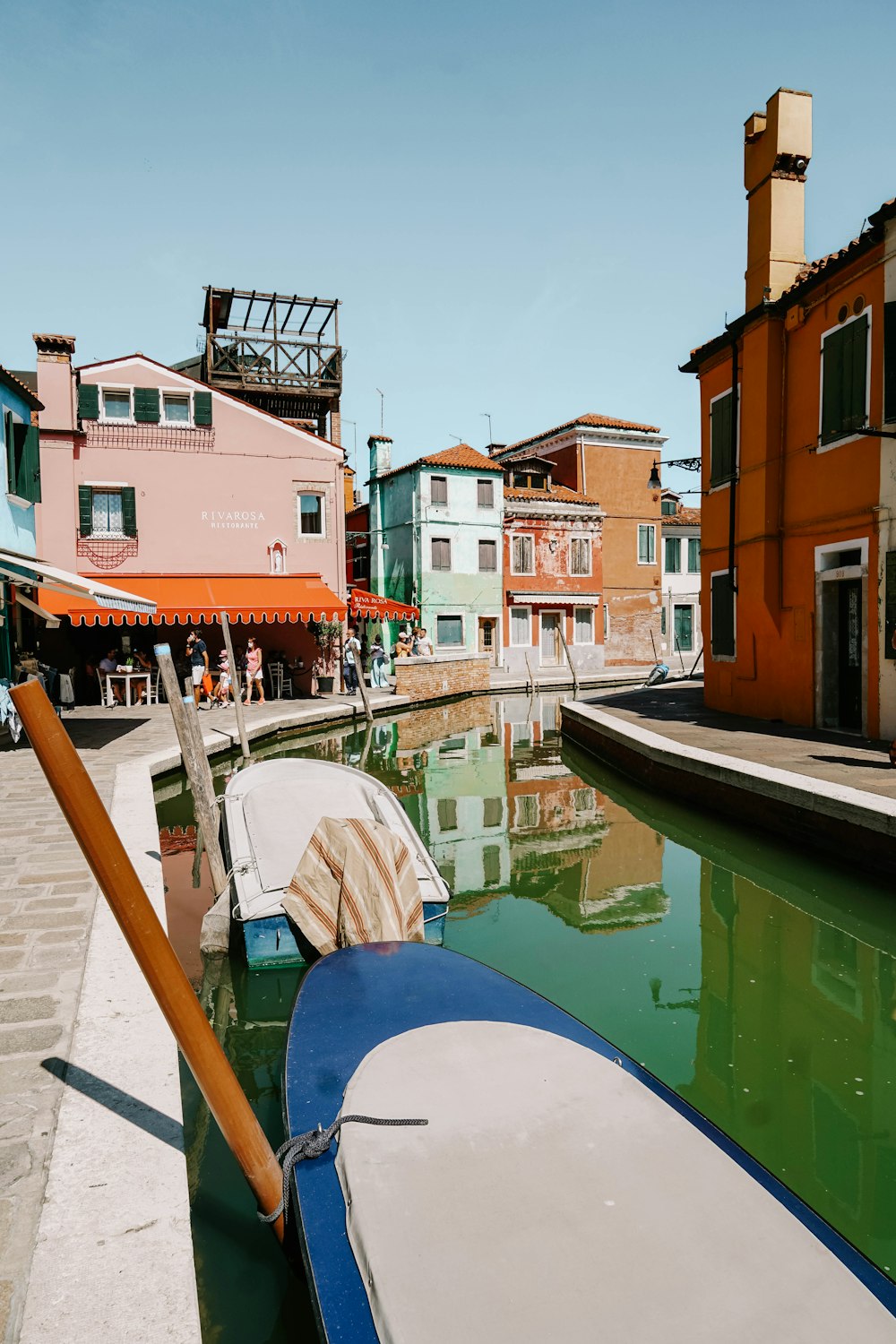 red and white concrete building beside body of water during daytime