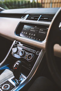 A sleek, modern car dashboard with a smartphone showing contact options