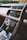A modern car interior showcasing a sleek dashboard with a touchscreen infotainment system displaying media and phone options. There are various control dials for air conditioning and other functions, along with a gear shift lever in the foreground.