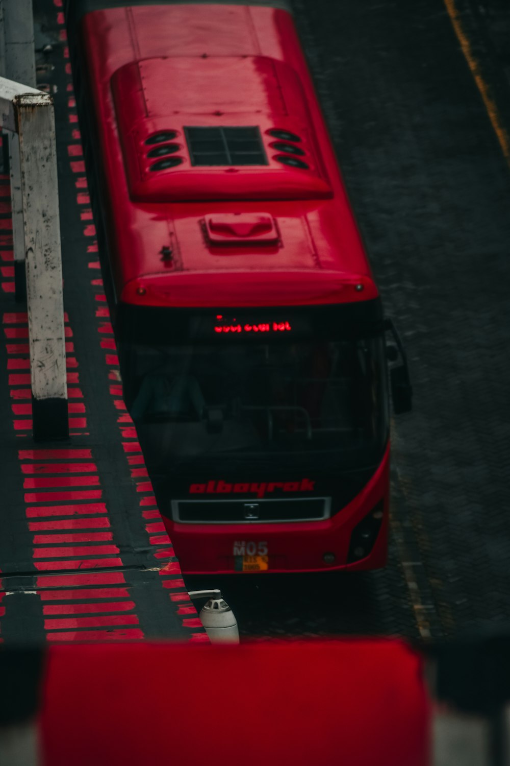 red and black bus on road