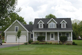 white and gray house near green grass field