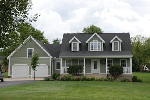 white and gray house near green grass field