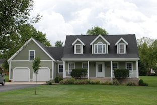 white and gray house near green grass field