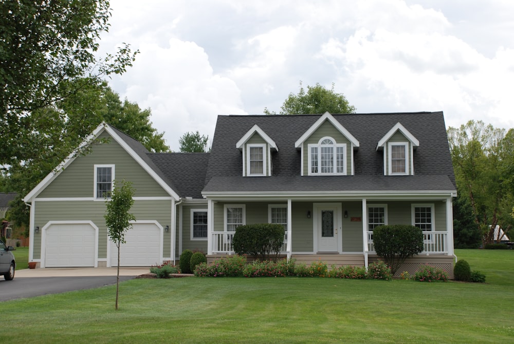 white and gray house near green grass field