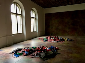 A bright and inviting studio filled with natural light, showcasing rolls of high-quality Spanish fabrics.