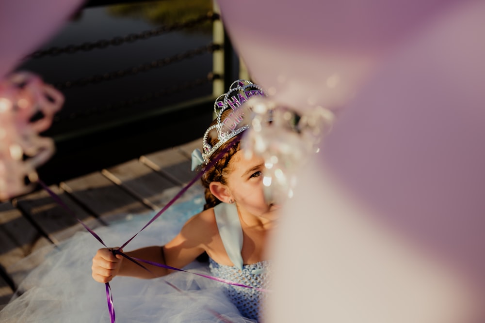 woman in blue and white floral dress wearing crown