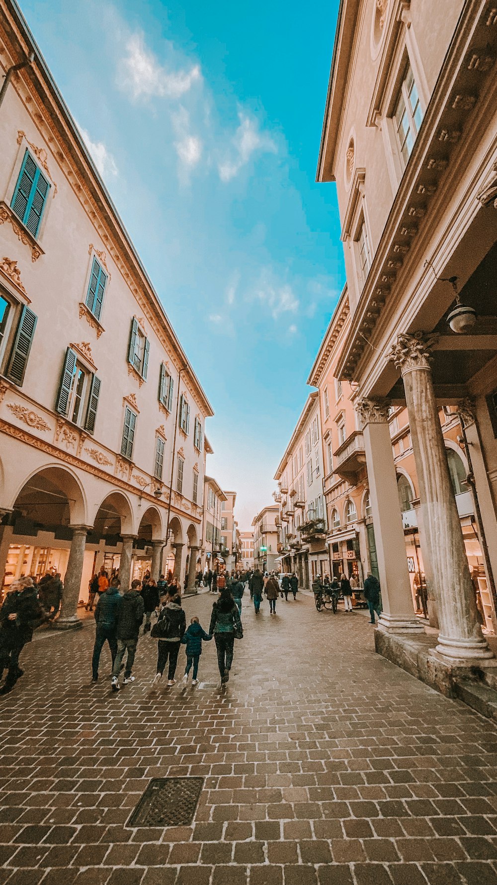 people walking on street between buildings during daytime