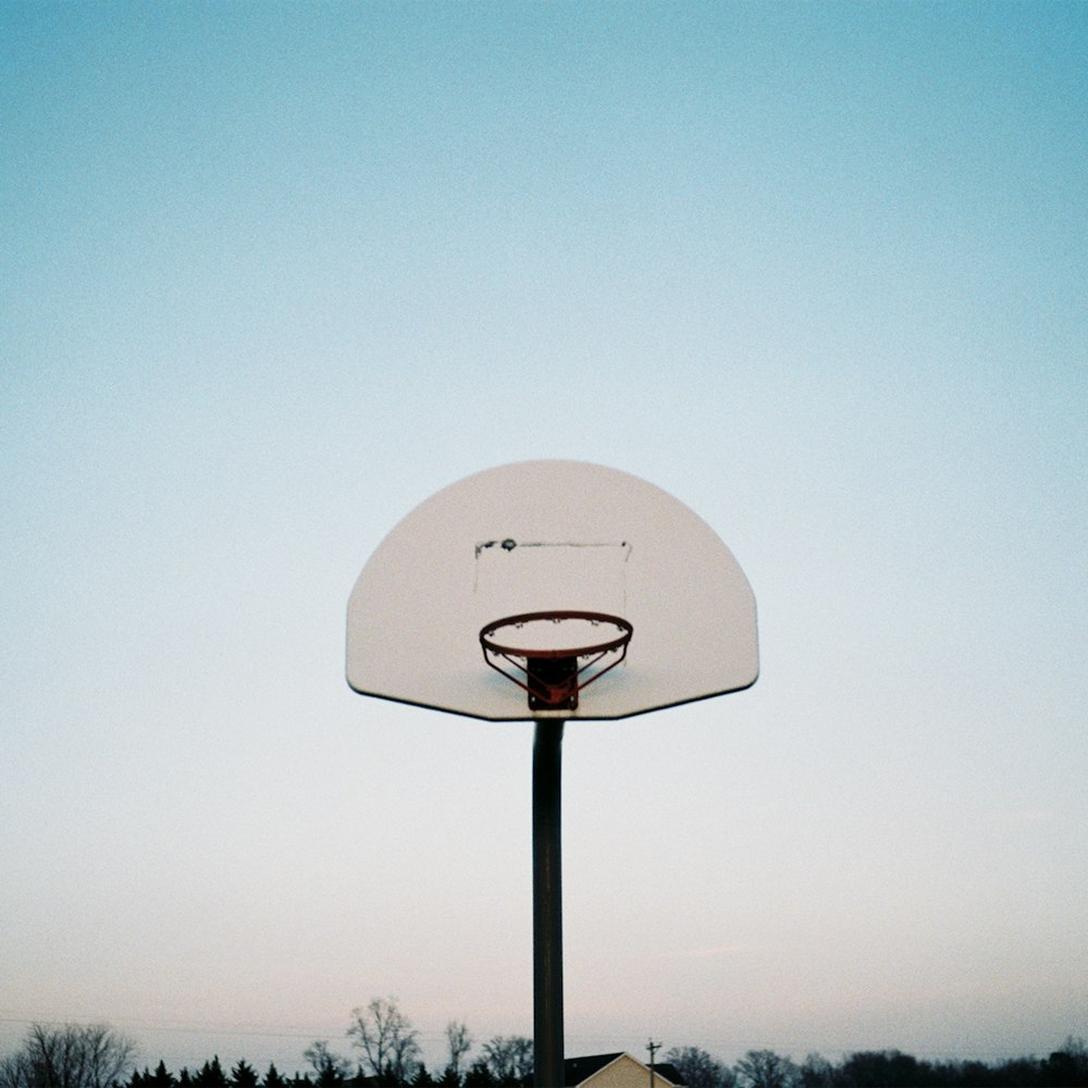 white basketball hoop under blue sky during daytime