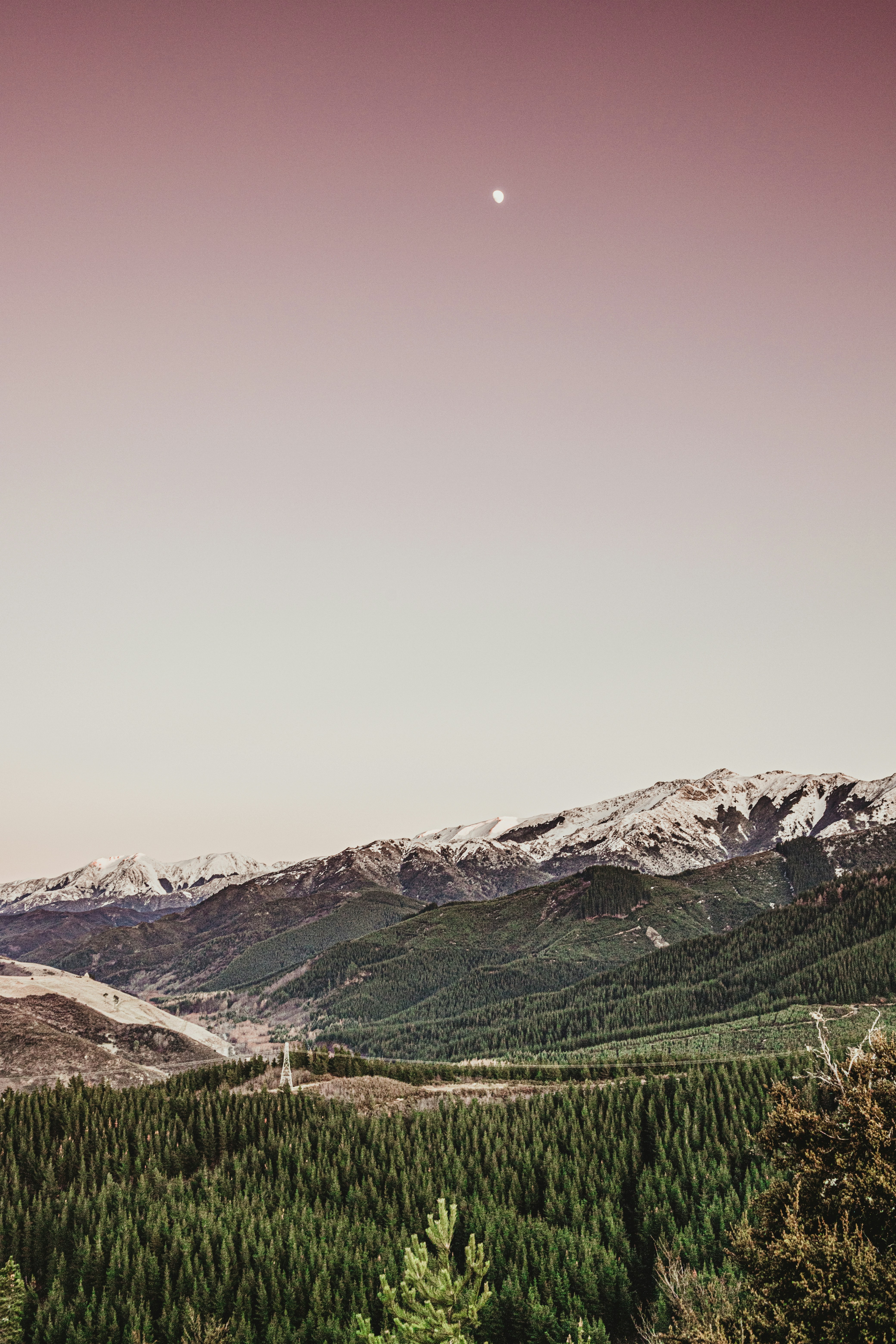 Green grass field near mountain under white sky during daytime photo ...