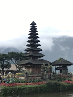 A tranquil temple surrounded by lush greenery and flowers.