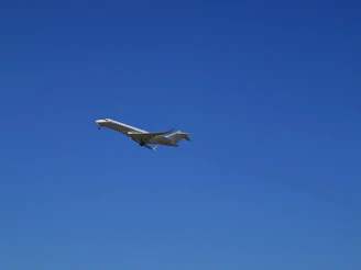 A sleek private jet preparing for takeoff against a clear blue sky.