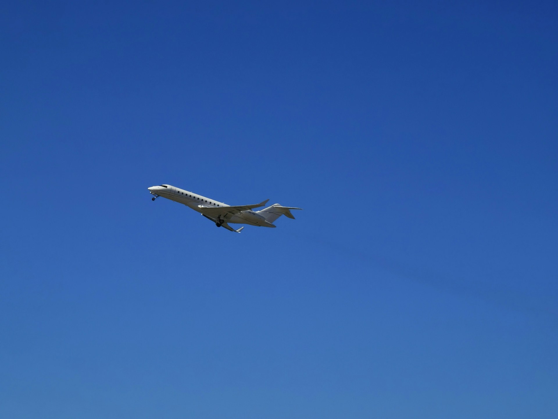 woman wearing yellow long-sleeved dress under white clouds and blue sky during daytime