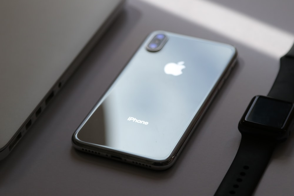 silver iphone 6 on white table