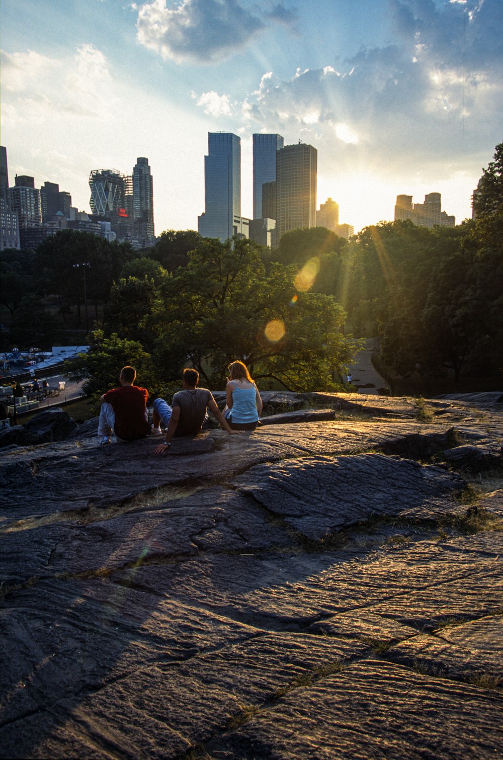 people sitting on brown wooden bench near body of water during daytime