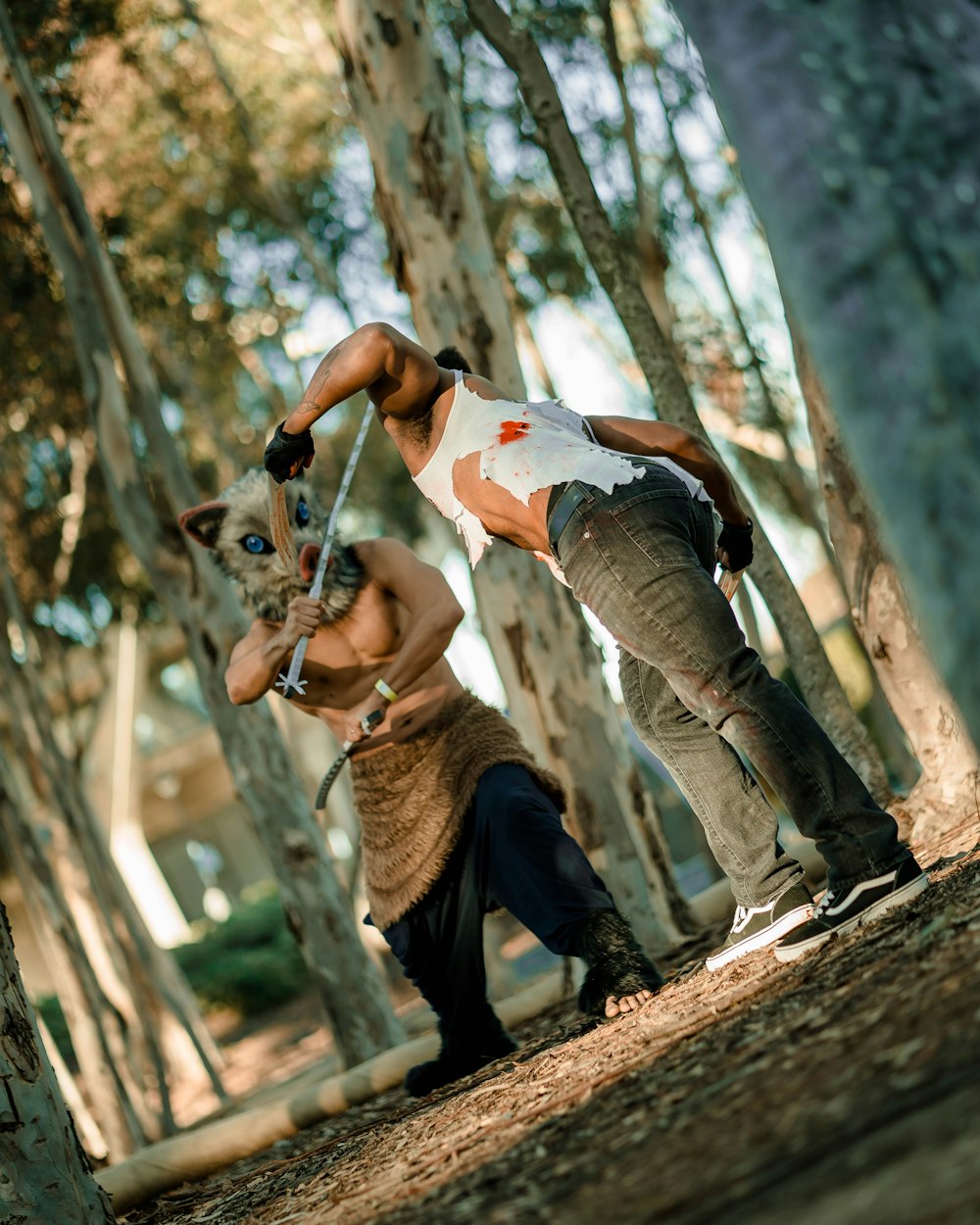 man in white t-shirt and black pants climbing on brown tree during daytime