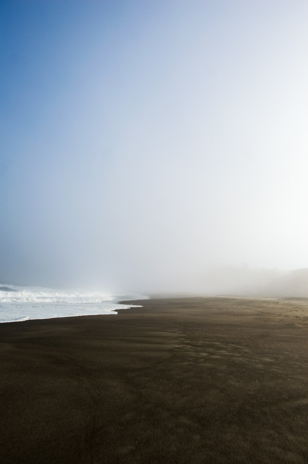 ocean waves crashing on shore during daytime