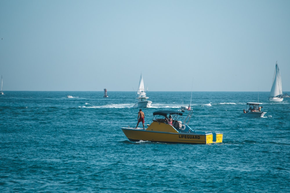 yellow and white boat on sea during daytime