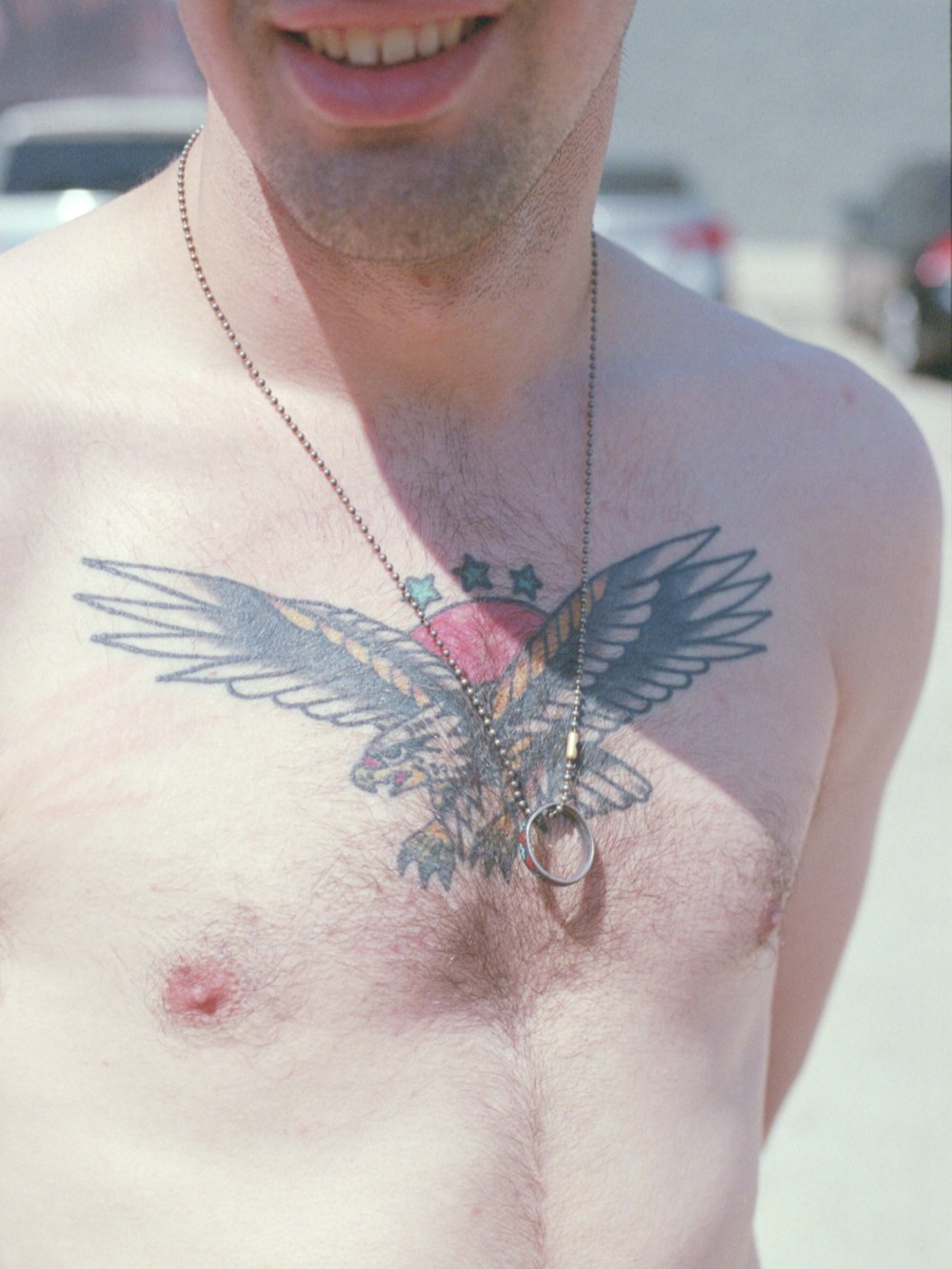 a man with a bird tattoo on his chest