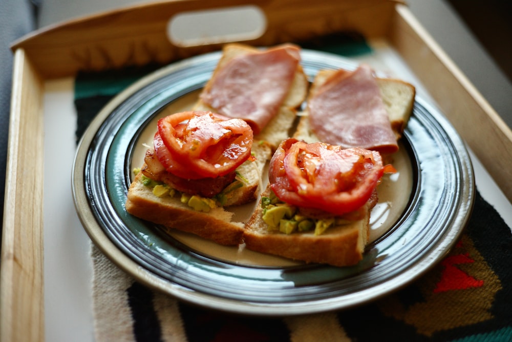 sliced ham on bread on white ceramic plate