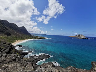 Scenic coastal view with turquoise waters and cliffs under a clear sky
