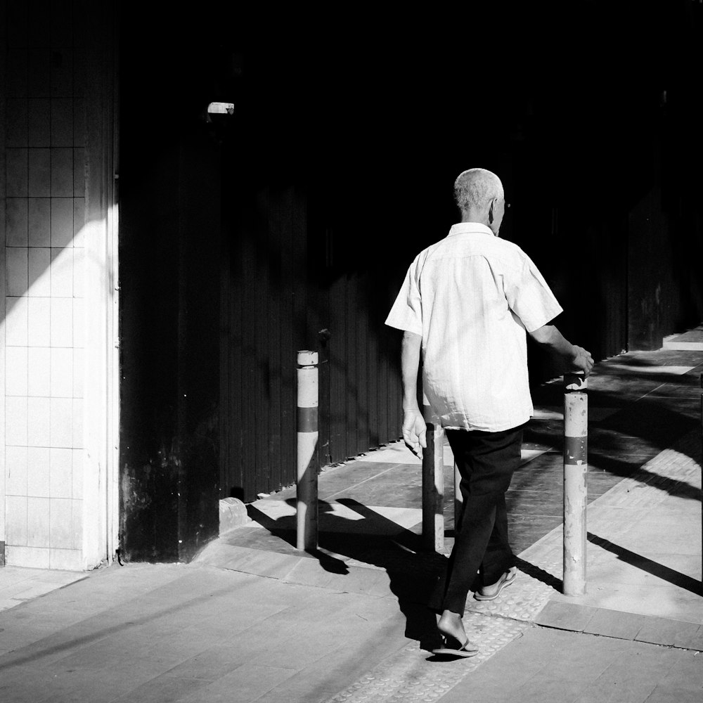 man in white dress shirt sitting on bench