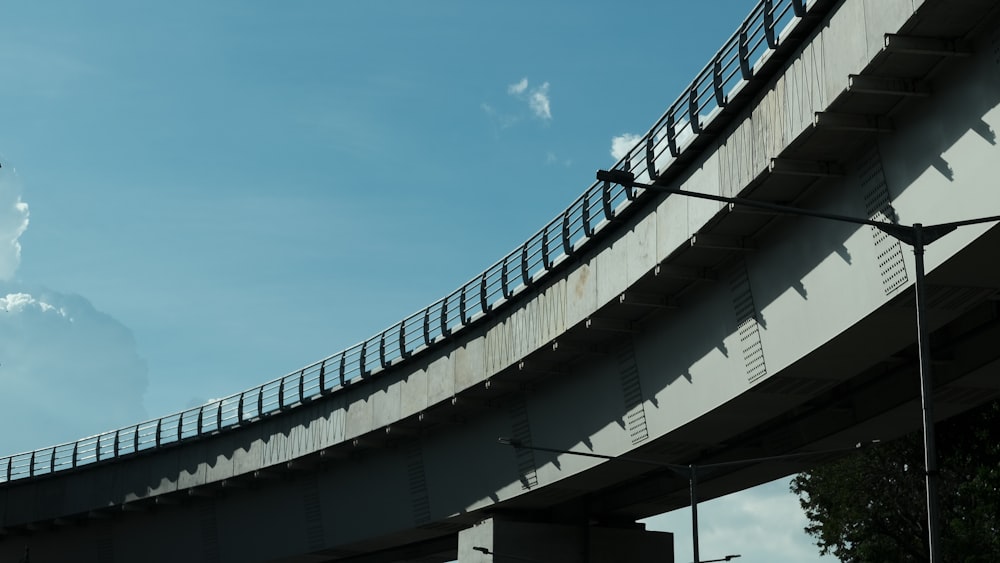 gray concrete bridge under blue sky during daytime