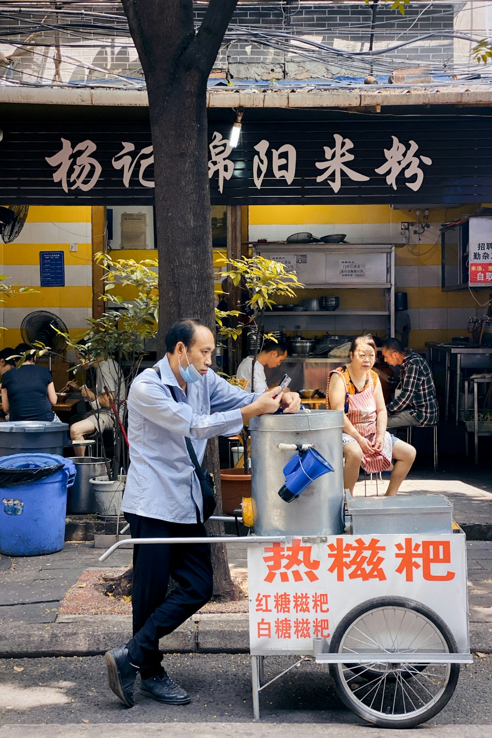 man in white button up shirt standing beside woman in black and white tank top during