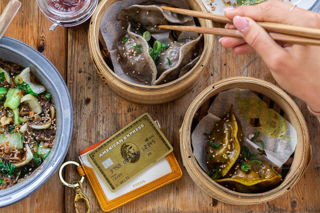 cooked food in brown wooden bowl, dim sums and amex credit card at Some Dim Sum