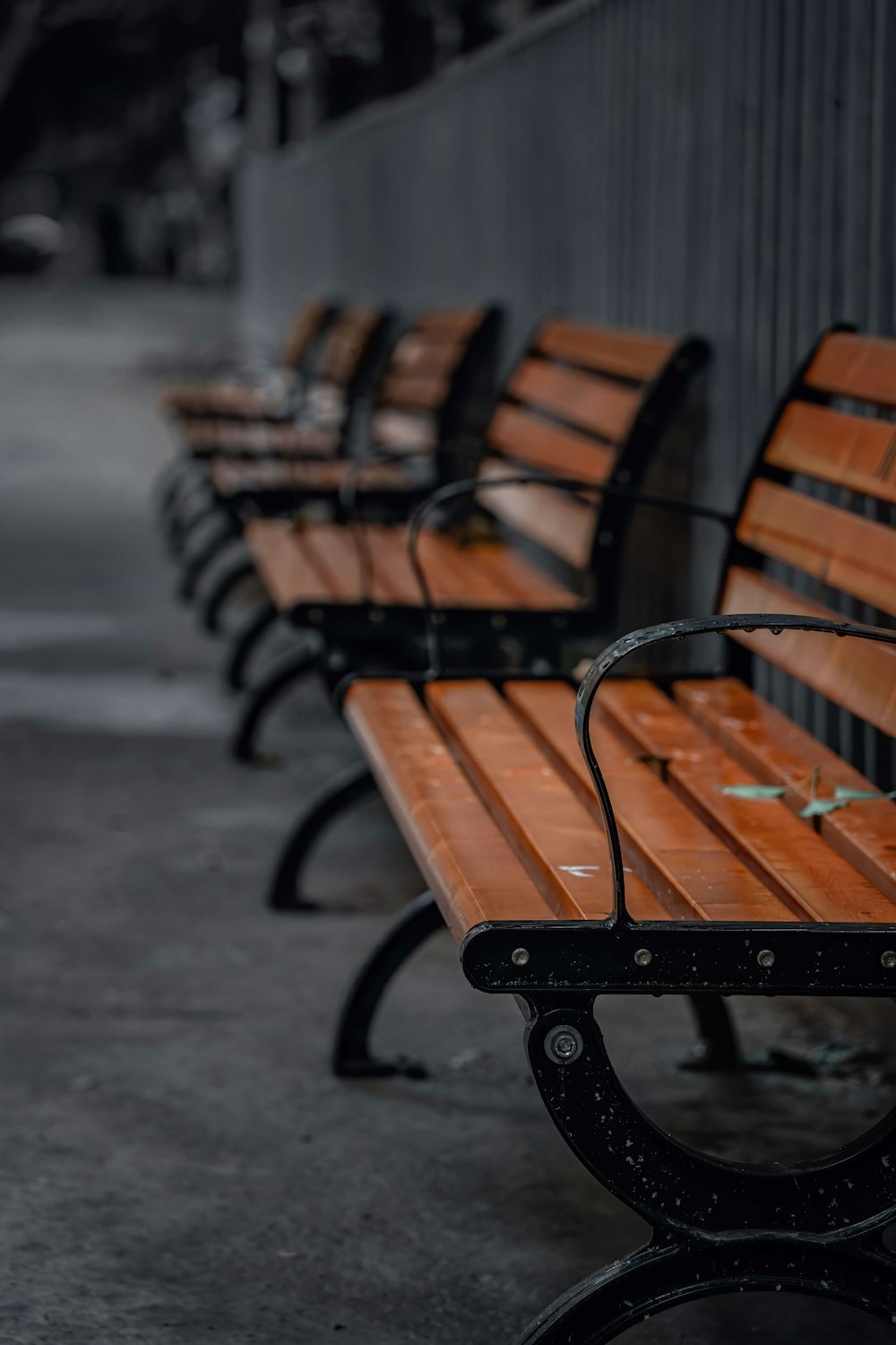 brown wooden bench on gray concrete floor