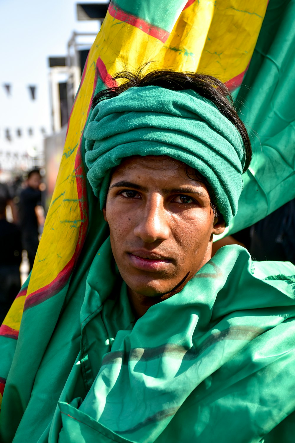 man in green and yellow scarf