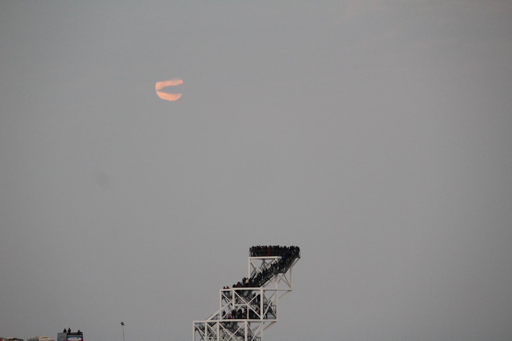 white and black satellite under white sky