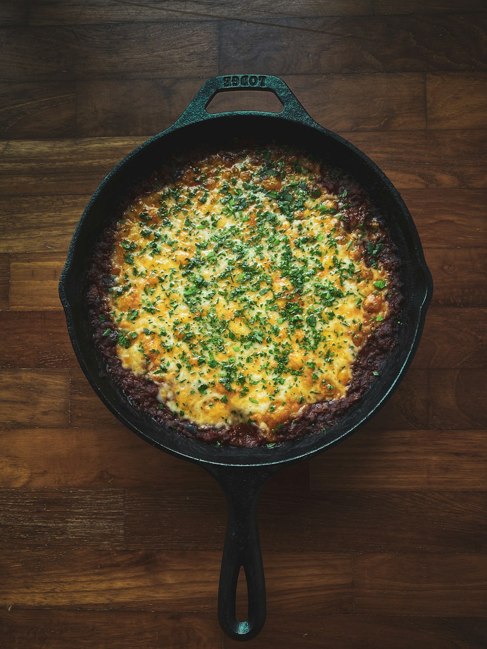 black frying pan on brown wooden table