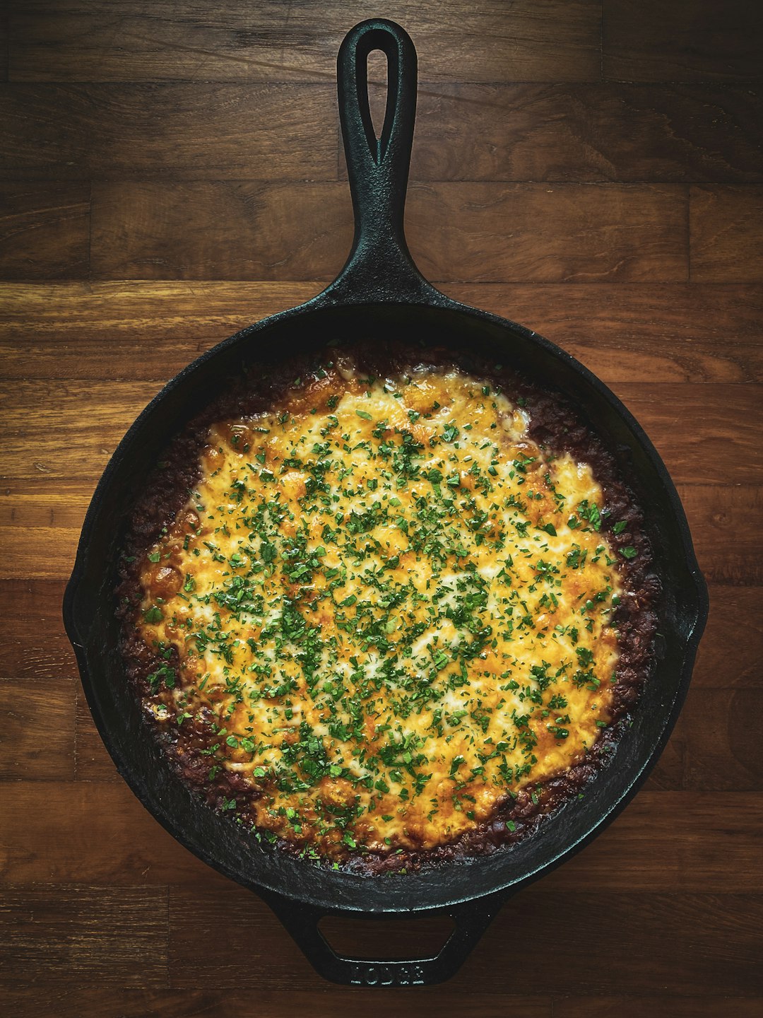 black frying pan on brown wooden table