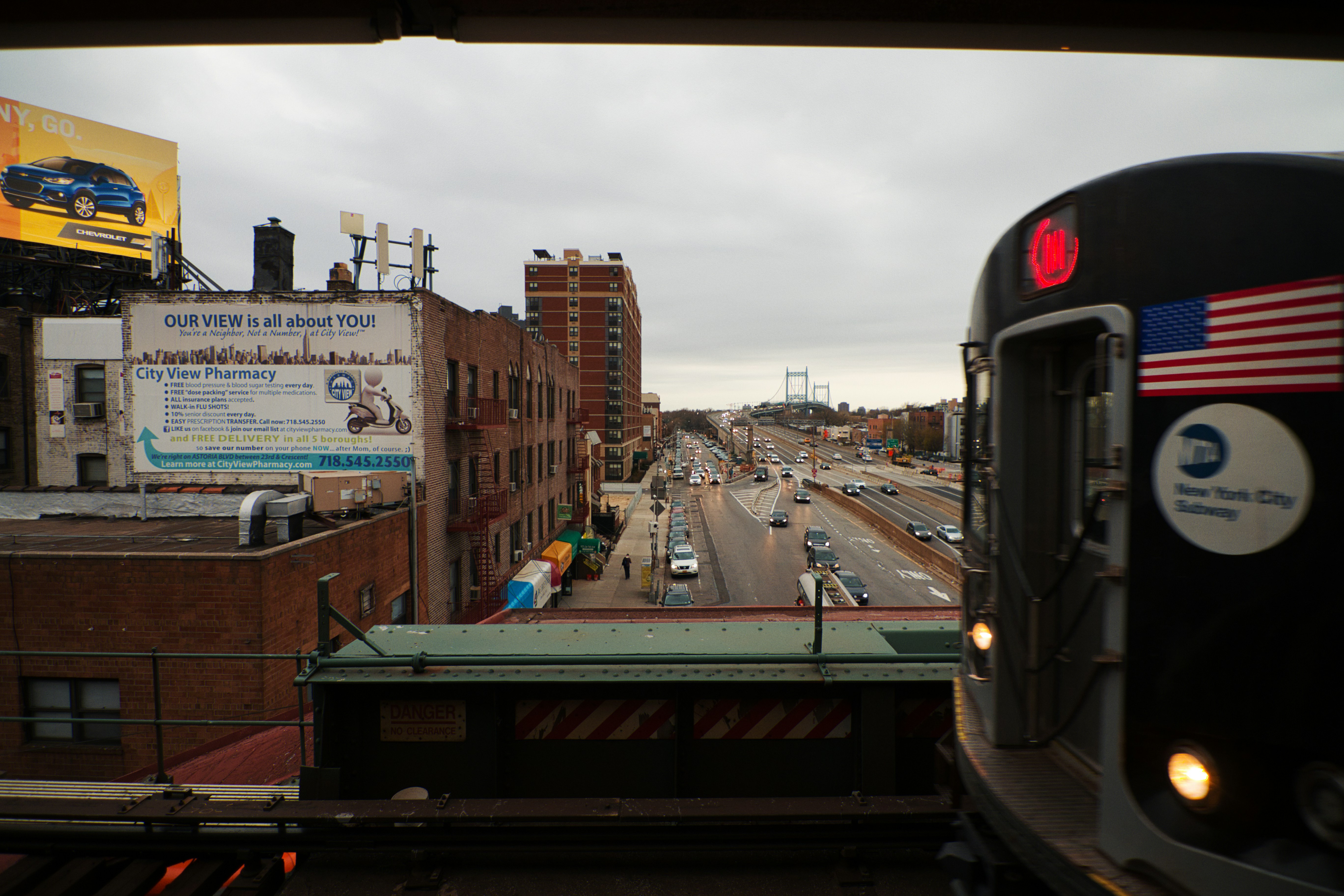 black train on rail road near city buildings during daytime, 