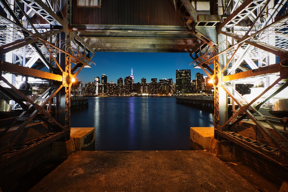 body of water near city buildings during night time