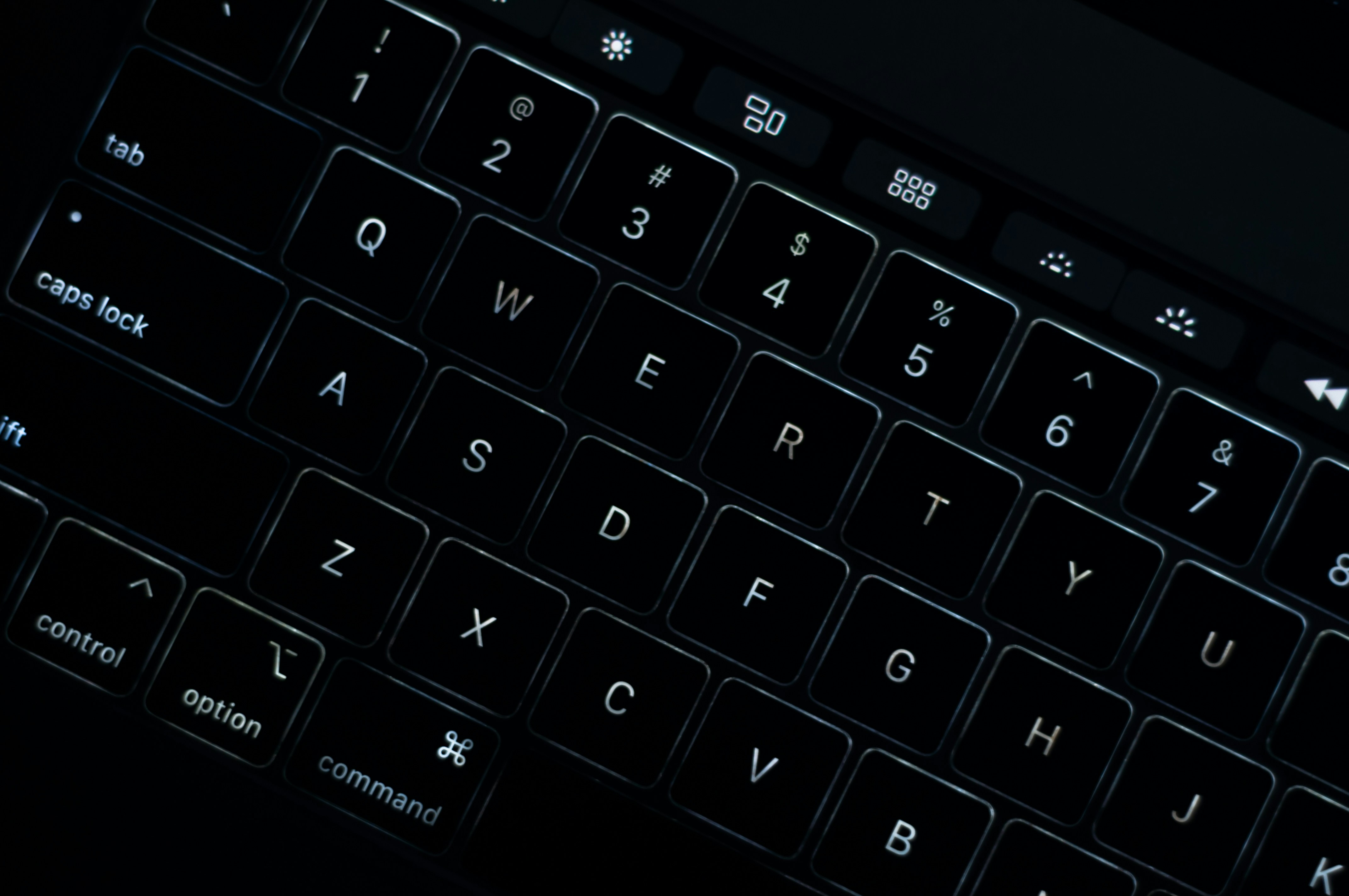 black computer keyboard on brown wooden table