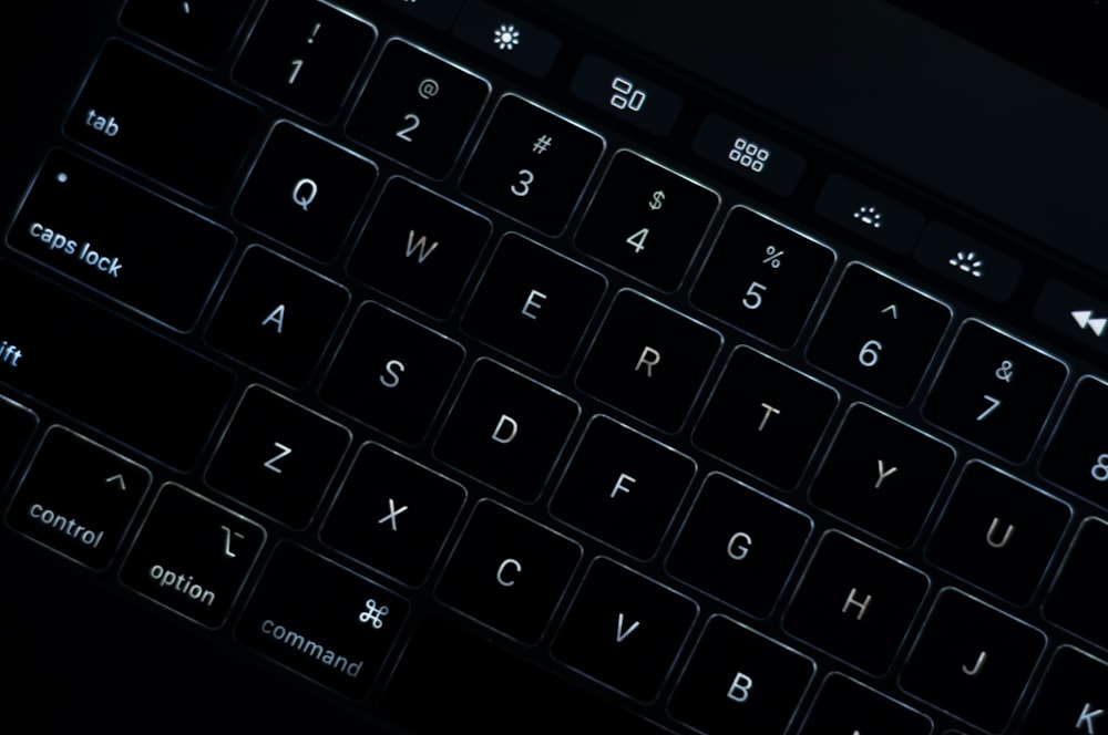 black computer keyboard on brown wooden table