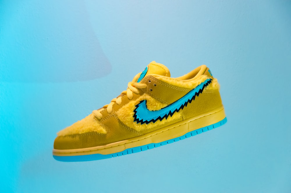 yellow and white nike low top sneakers photo – Free Footwear Image on  Unsplash