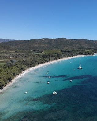 Aerial view of a scenic coastline with clear blue waters.