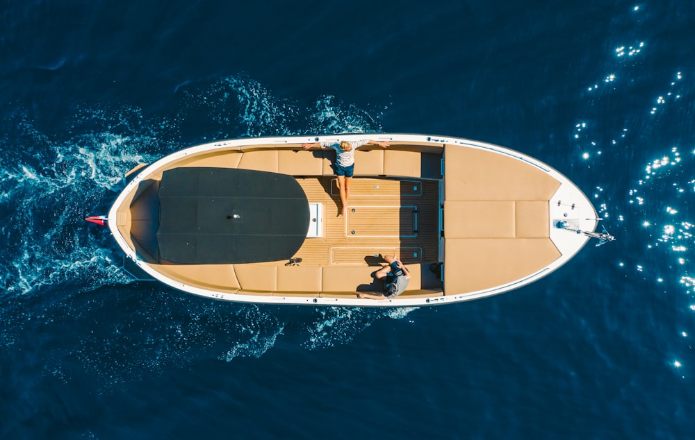 yellow and white boat on blue water