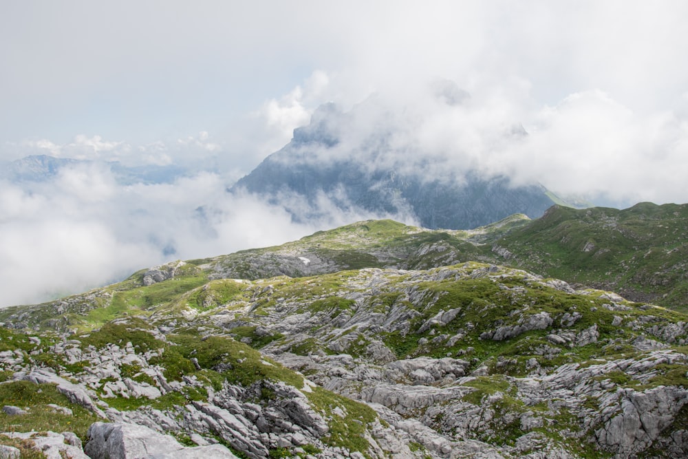 green and gray mountain under white clouds during daytime