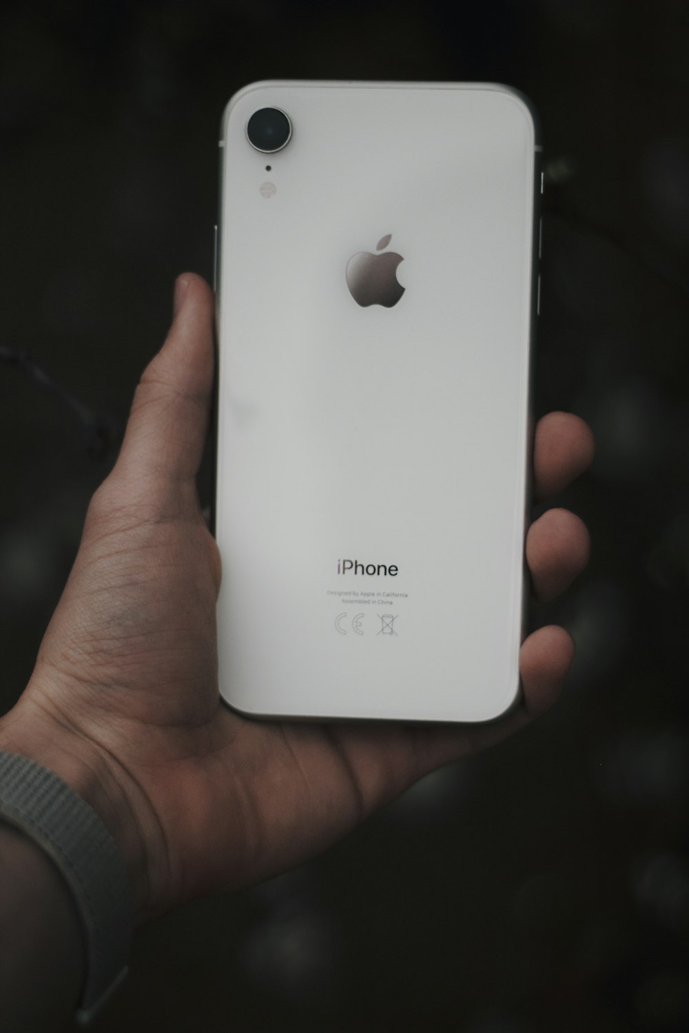 person holding white iphone 5 c